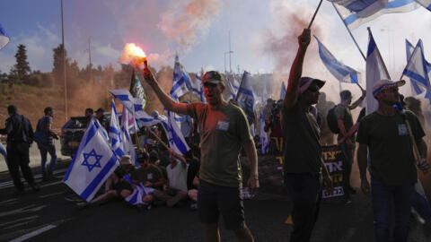 Israel protesters block highways, throng airport after passage of key clause in judicial overhaul