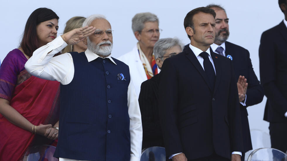 Indian Prime Minister Narendra Modi salutes Indian troops alongside French President Emmanuel Macron during the Bastille Day military parade on Friday, July 14, 2023 in Paris.