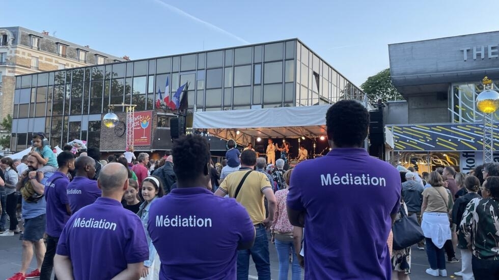 Social workers stand guard on the Place du 11-Novembre, where the town hall is located, in the southwest Paris suburb of Malakoff, France, July 13, 2023. 